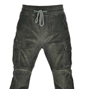 Detail of olive green corduroy motorcycle pants with elastic waist and cargo pockets