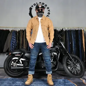 Detail of khaki motorcycle riding jacket and denim biker pants with pleated knees