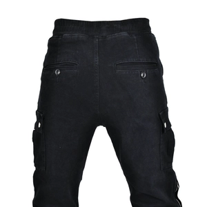 Detail view of black motorcycle jeans featuring elastic waist and large cargo pockets
