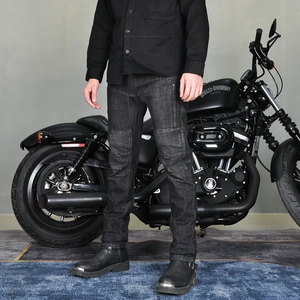 Close-up of slim-fit grey motorcycle jeans with accordion stretch panels on the knees