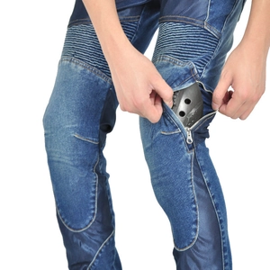 Detail of inserting protective knee pads into motorcycle jeans with accordion panels