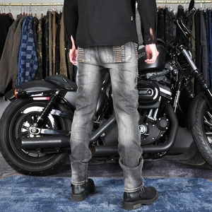 Detail of stone washed denim jeans with pleated back pockets and motorcycle scene
