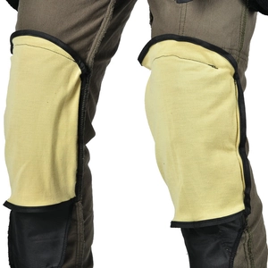 Detail of yellow motorcycle knee protector insert on green corduroy cargo pants