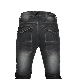 Detail of dark grey motorcycle jeans with biker pleats, leather patch and orange stitching