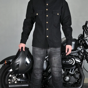 Detail of black motorcycle riding shirt and gray armored jeans with protective knee pleats