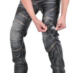 Detail of grey riding jeans with protective knee pads and elastic accordion panels
