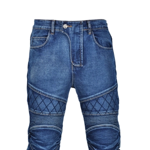 Macro view of blue motorcycle denim jeans showing biker-style quilting and knee pleats