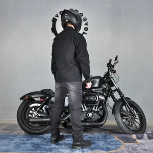 Rear view of black motorcycle jacket and grey riding jeans with professional protective gear