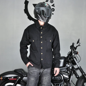 Close-up of black cotton canvas motorcycle shirt with metal buttons and cargo pockets