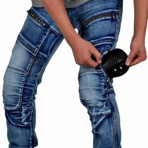 Detail of blue biker jeans with pleated knees and zippers showing small snakeskin pouch