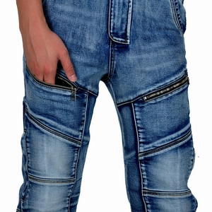 Close-up of motorcycle jeans featuring vintage wash and multiple metal zipper pockets