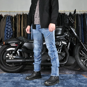 Detail of light blue motorcycle jeans with ribbed knee panels and slim fit design