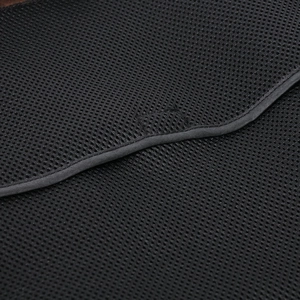 Close-up of black breathable honeycomb mesh fabric and stitching on motorcycle jacket