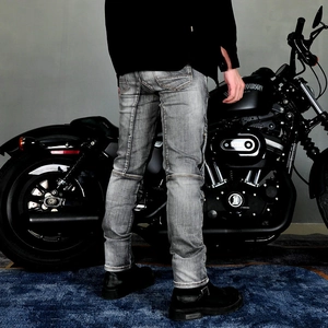 Detail of grey motorcycle jeans with vintage wash and reinforced stitching on the back