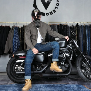 Rugged retro motorcycle jacket and denim jeans for men riding on classic motorbike