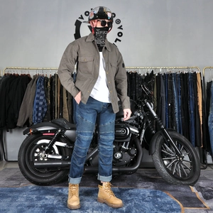 Detail view of motorcycle riding jeans with protective knee pleats and casual biker shirt