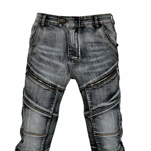 Detail of washed grey motorcycle jeans featuring metal zipper pockets and industrial stitching