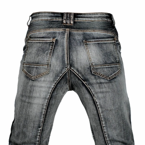 Detail of gray washed biker jeans with orange stitching and accordion stretch panels