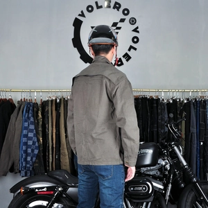 Detail of olive green motorcycle jacket with back exhaust vents and durable cotton fabric