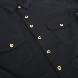 Detail of black motorcycle riding shirt with vintage bronze metal snaps and dual chest pockets
