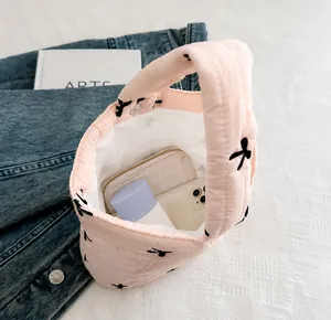 Spacious interior of pink quilted tote bag showing phone and wallet storage capacity