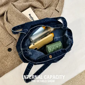Macro view of the spacious internal capacity of the vintage denim tote bag