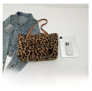 Detailed top view of large plush leopard print tote bag with brown leather strap
