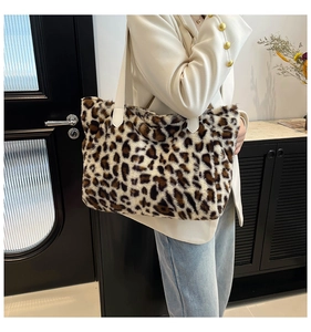 Detailed view of plush leopard print faux fur tote bag with a beige shoulder strap