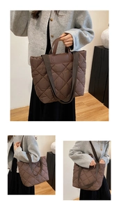 Detailed view of dark brown quilted tote bag with diamond stitching and dual straps