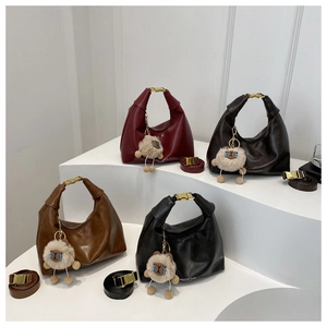 Group view of vintage half-moon handbags in burgundy, brown, caramel, and black colors