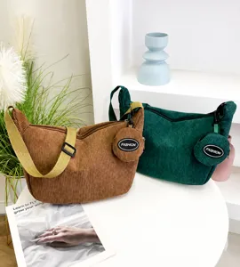 Detailed close-up of retro corduroy crescent bags with matching round coin purses