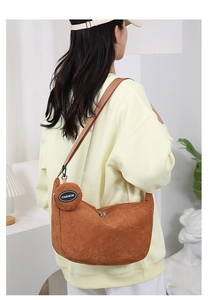 Detail of ginger corduroy crossbody bag with removable round coin purse and logo