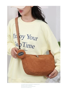 Detail of brown corduroy crescent bag with adjustable strap and matching round coin purse