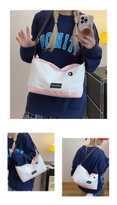Viste multiple di una borsa a tracolla in tela rosa e bianca con cinturino regolabile