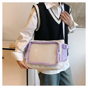 Detail of white and purple Ita bag showing the transparent window and adjustable strap
