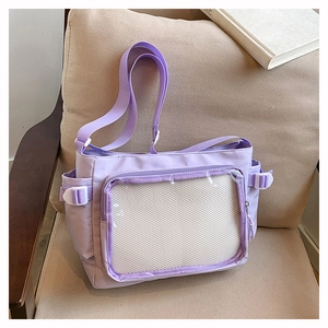 Detail view of purple ita bag with a large clear PVC window and adjustable side buckles