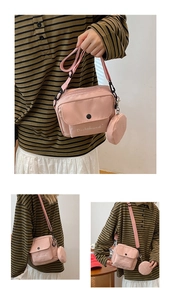 Detail of pink canvas crossbody bag with mini pouch and Dachshund lettering detail