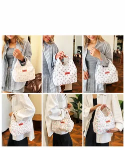 Floral print lunch bag detail showing soft cotton fabric and stylish top handle design
