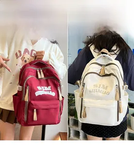 Detail view of nylon backpack with multi-layer zippers, logo print and side buckles
