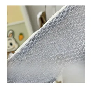 Detail of grey breathable mesh shoulder strap with honeycomb texture for school backpacks