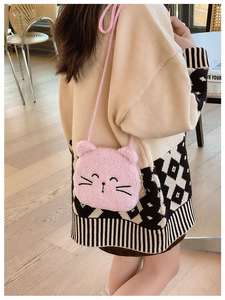 Detail of pink plush cat crossbody bag featuring a golden flower zipper and soft faux fur