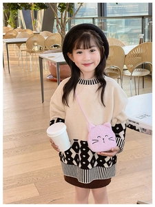 Close-up of cute pink plush kitten crossbody bag shown on a young girl in a cafe