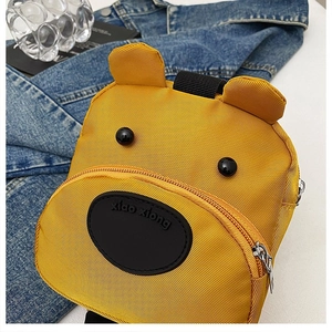 Close-up of the yellow bear-shaped toddler backpack with 3D ears and durable fabric