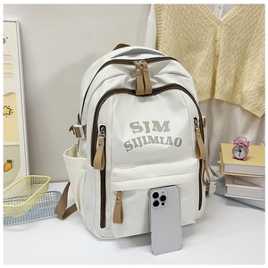 Detail of white nylon backpack featuring brown zippers and spacious side water bottle pockets