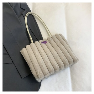 Détail du sac cabas en peluche beige clair avec rayures verticales et étiquette violette