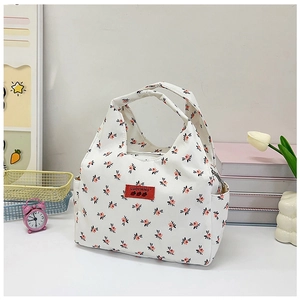 Close-up of floral canvas lunch bag with zipper closure and side pocket details