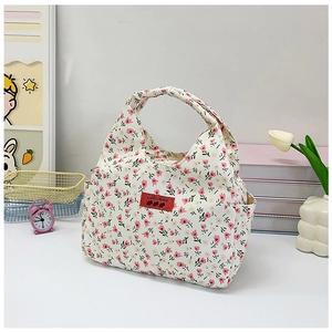 Detail view of floral canvas lunch bag with pink flower pattern and logo embroidery