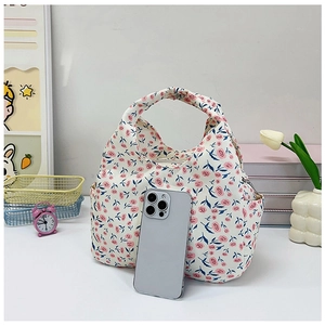 Floral bento handbag with smartphone inside showing storage capacity and side pocket