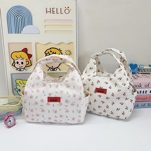 Floral canvas lunch bags with pink and red flower patterns and top handles