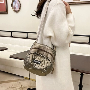 Metallic quilted crossbody puffer bag with FASHION patch and wide woven shoulder strap